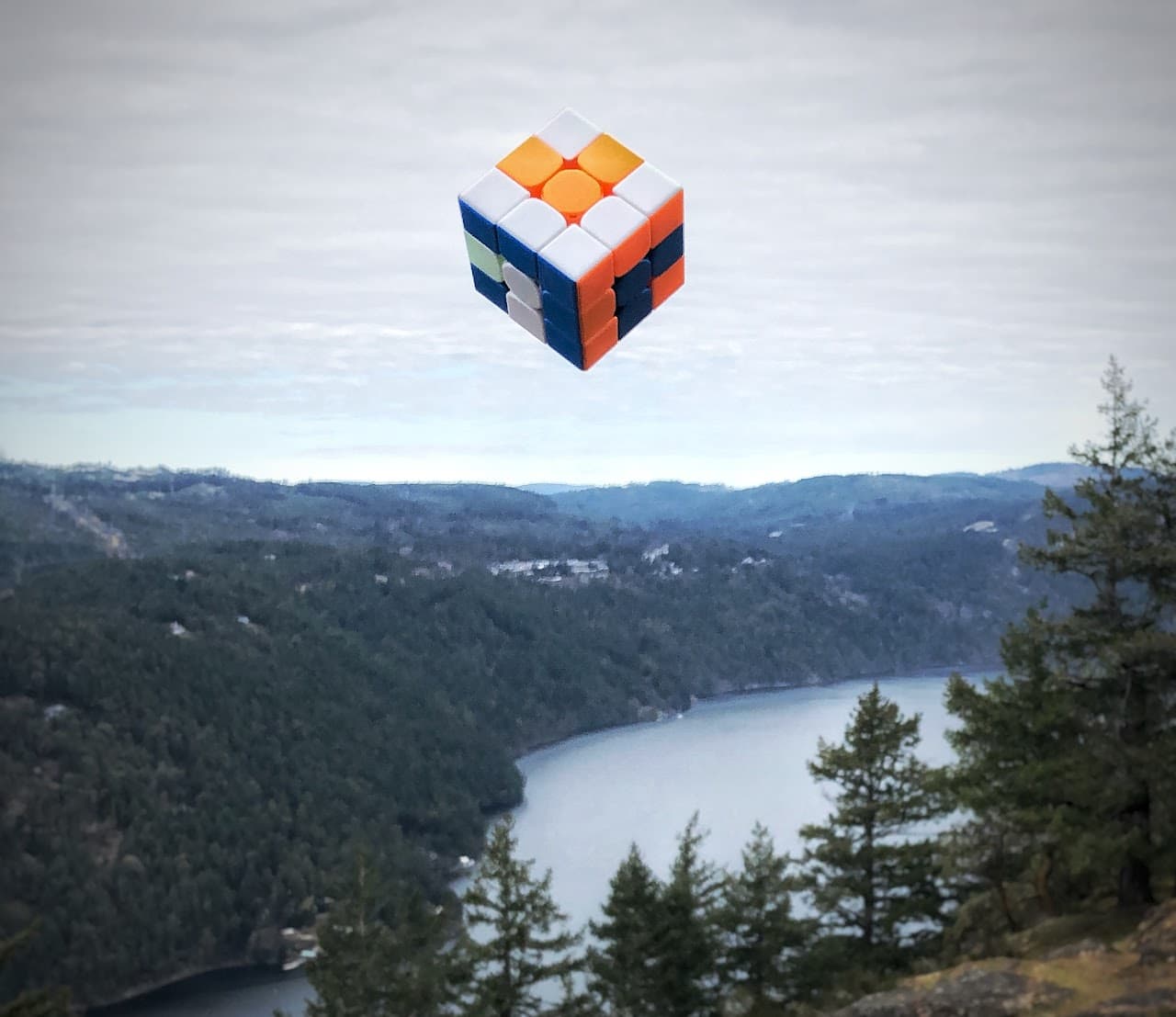 A Rubik's cube flying above Mount Tolmie in Victoria