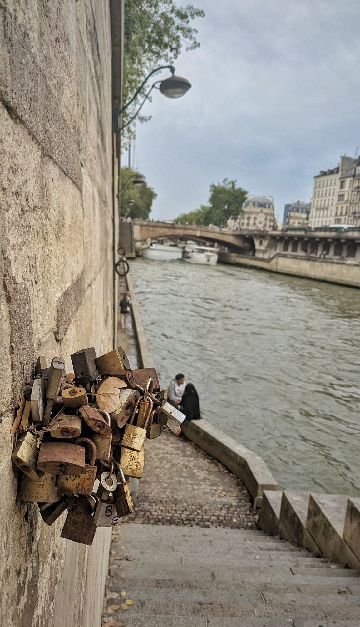 Padlocks from tourists accumulate like tumours on a Paris walkway